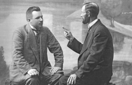 Vanhassa kuvassa kaksi ihmistä keskustelee.